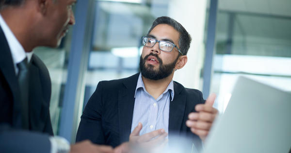 Two business men in an office having an animated discussion.