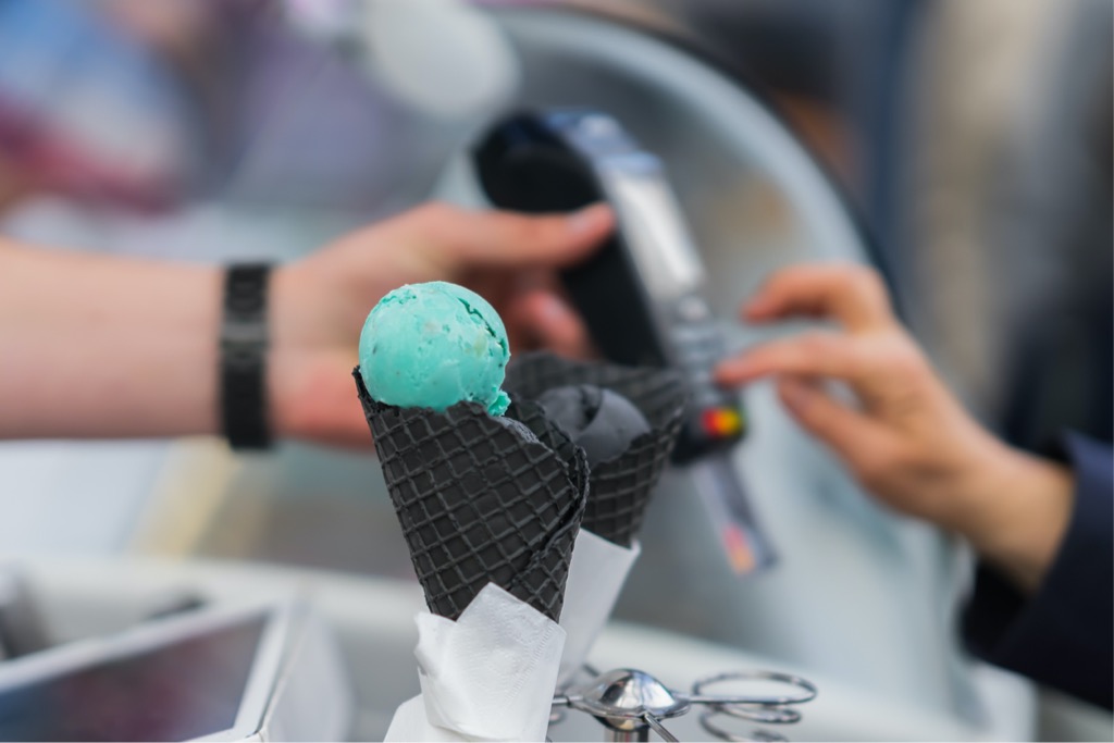 Closeup Of Icecream In Black Waffle Cones Hands Of Customer Paying A Picture Id692805088